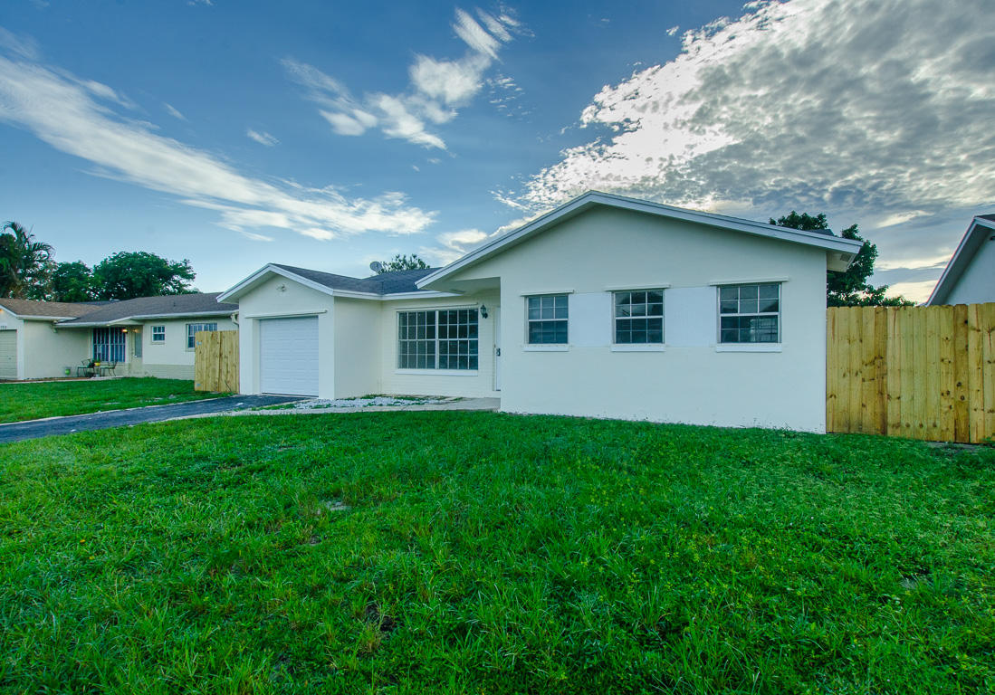 22710 Family Circle Boca Raton, FL 33428 - Photo 5 of 28 a front view of house with yard and green space