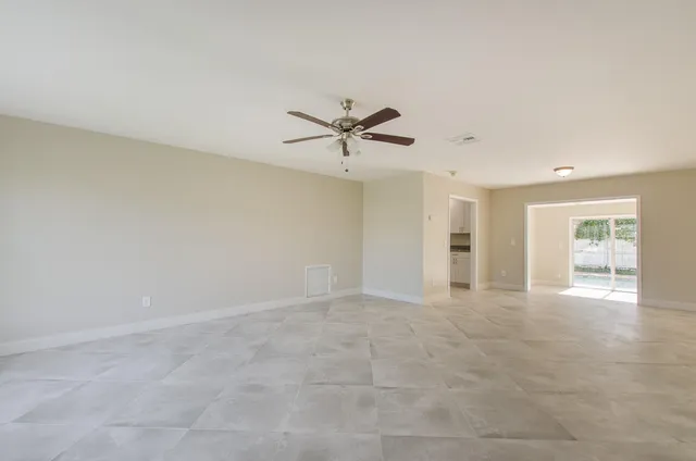 an empty room with fan and ceiling fan