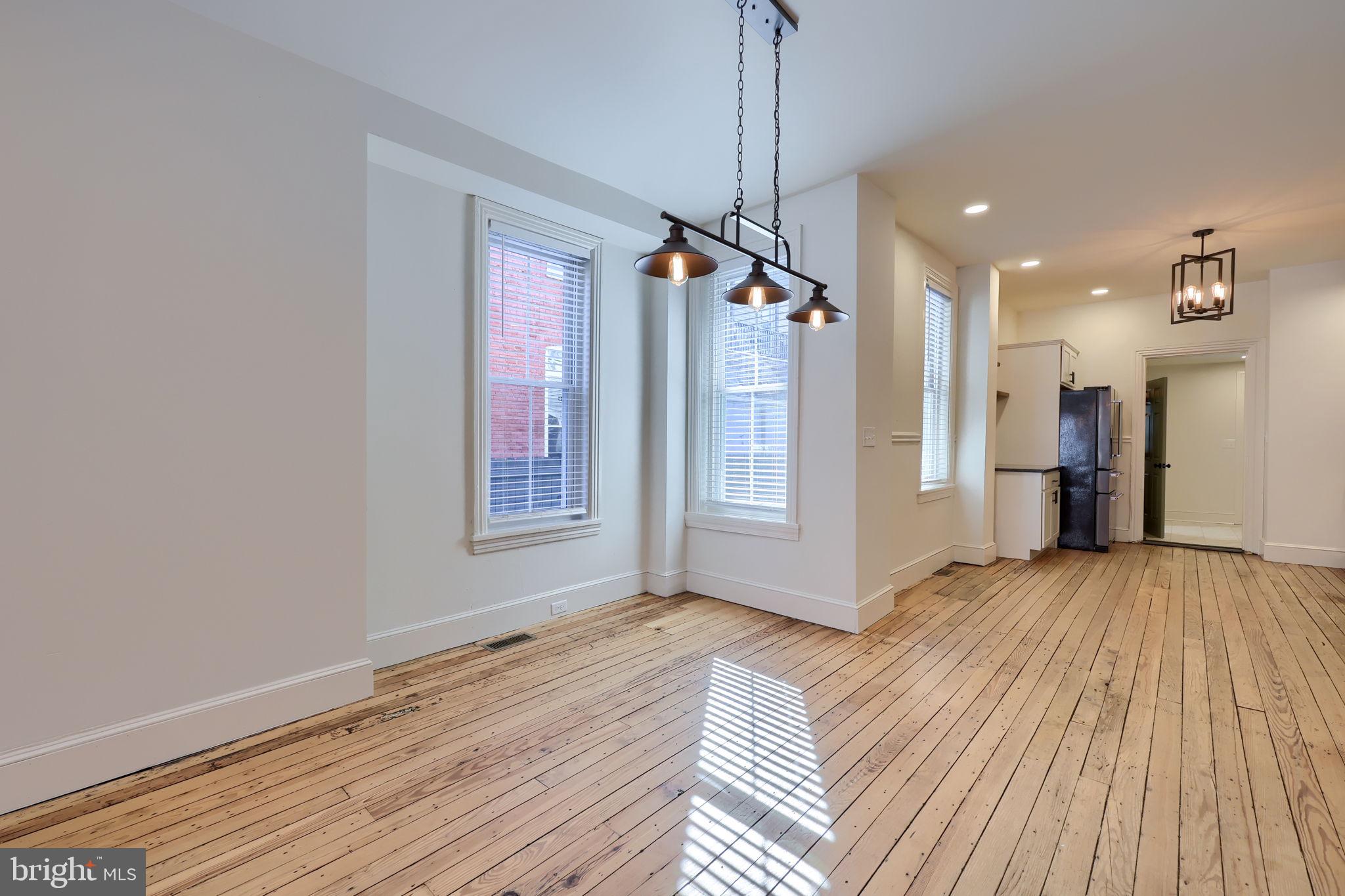 134 South 2nd Street Columbia, PA 17512 - Photo 14 of 47 a view of an empty room with window wooden floor and a kitchen