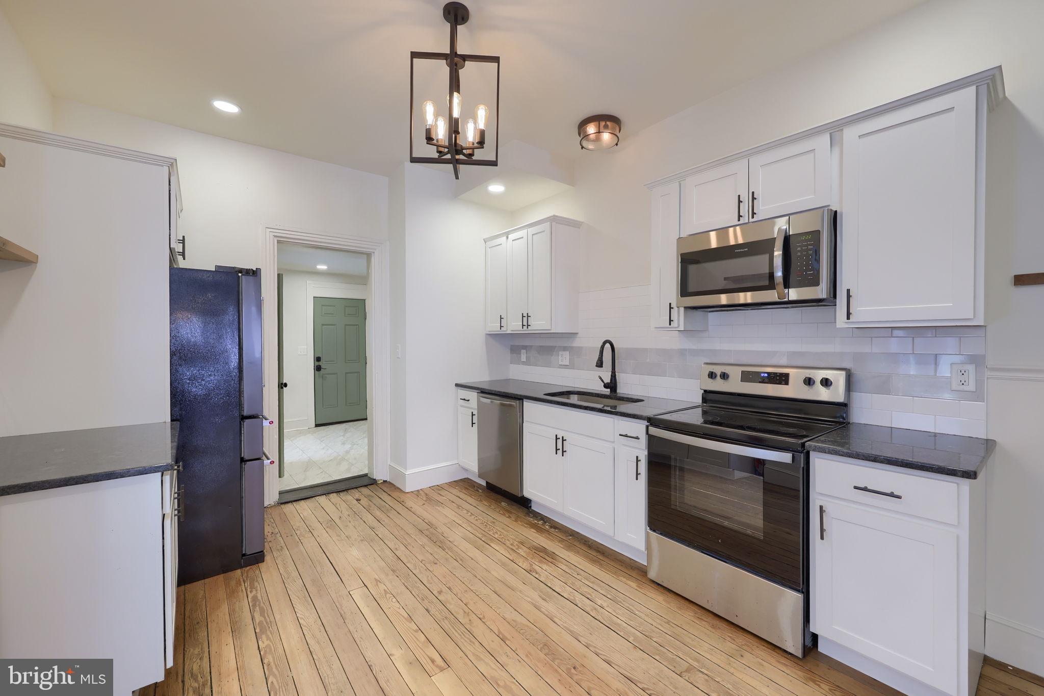 134 South 2nd Street Columbia, PA 17512 - Photo 18 of 47 a kitchen with stainless steel appliances granite countertop a stove a refrigerator and a microwave