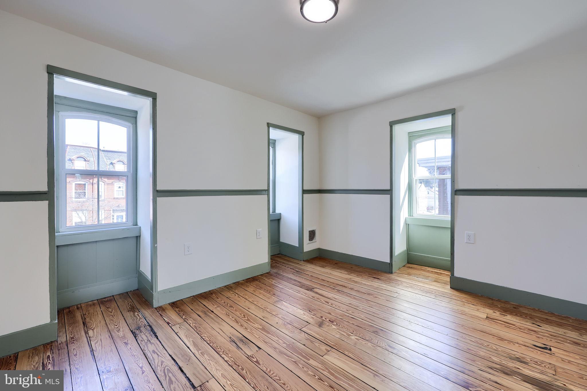 134 South 2nd Street Columbia, PA 17512 - Photo 27 of 47 an empty room with wooden floor and windows
