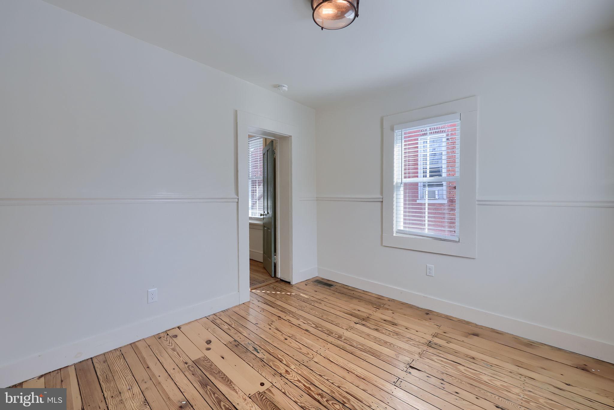 134 South 2nd Street Columbia, PA 17512 - Photo 32 of 47 an empty room with wooden floor and windows