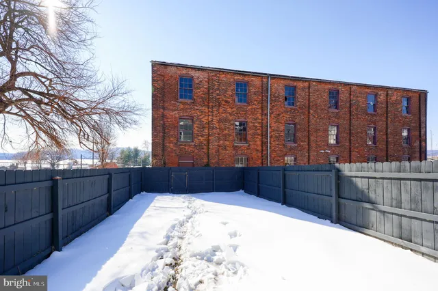 a view of a room with wooden floor and stairs