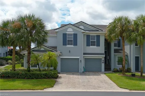a front view of a house with a garden and a yard