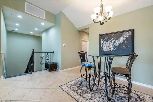a view of a dining room with furniture and chandelier