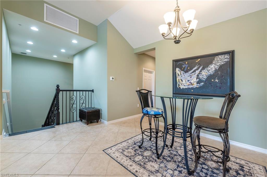 16550 Goldenrod Lane, Unit 201 Fort Myers, FL 33905 - Photo 13 of 45 a view of a dining room with furniture and chandelier
