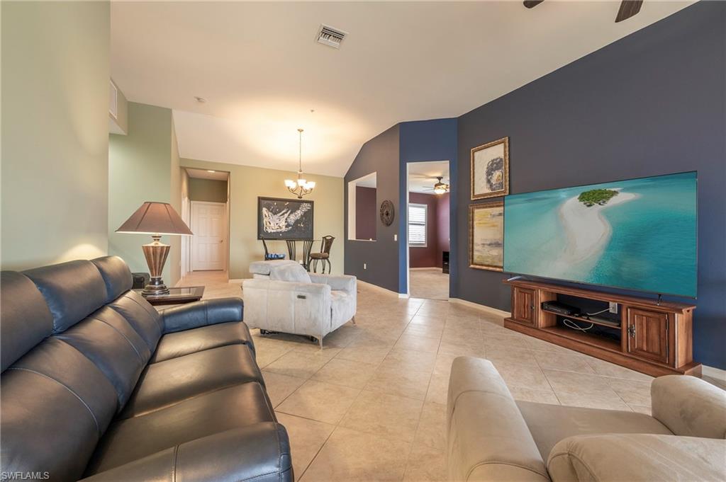 16550 Goldenrod Lane, Unit 201 Fort Myers, FL 33905 - Photo 16 of 45 a living room with furniture and a flat screen tv