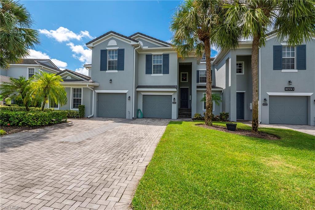 16550 Goldenrod Lane, Unit 201 Fort Myers, FL 33905 - Photo 2 of 45 a front view of a house with a yard
