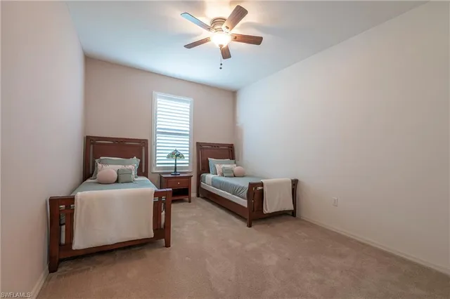 a living room with furniture and a ceiling fan