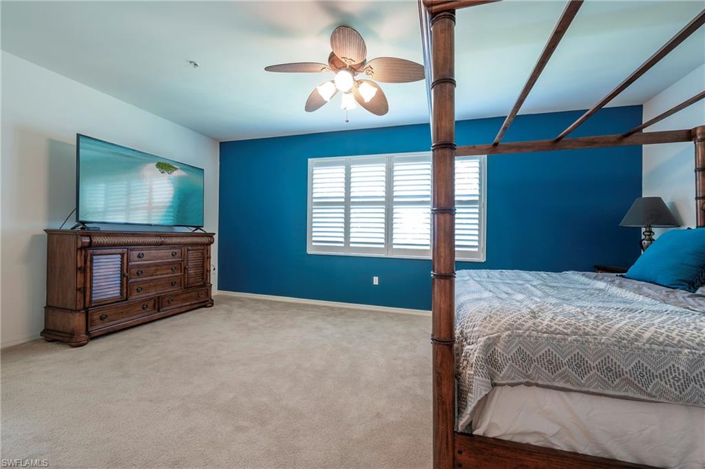 16550 Goldenrod Lane, Unit 201 Fort Myers, FL 33905 - Photo 31 of 45 a bedroom with a bed and a flat screen tv