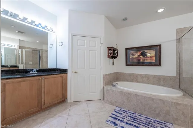 a bathroom with a bathtub a sink and a mirror