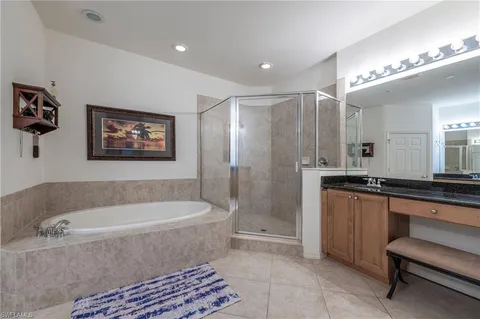 a bathroom with a bathtub a sink and a shower