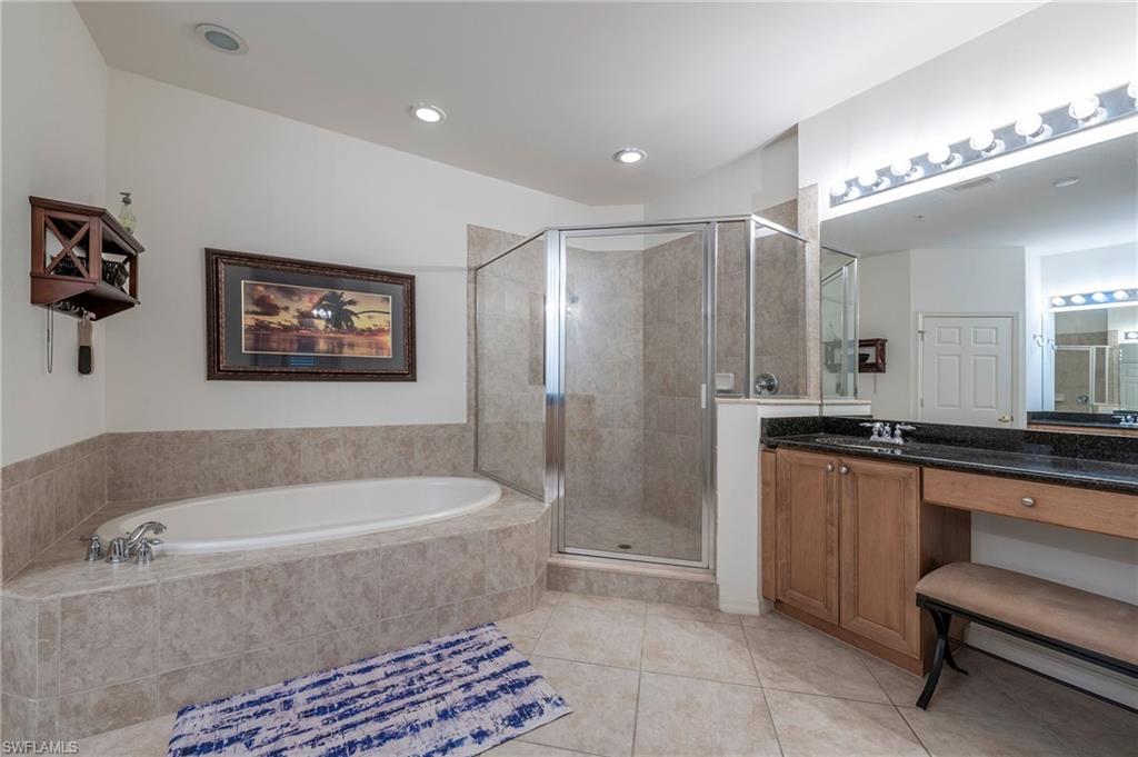16550 Goldenrod Lane, Unit 201 Fort Myers, FL 33905 - Photo 33 of 45 a bathroom with a bathtub a sink and a shower