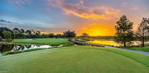 a view of a golf course with a lake view