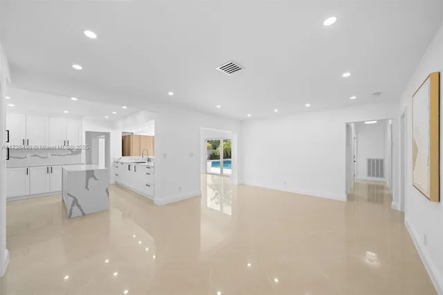 a view of kitchen with furniture and refrigerator