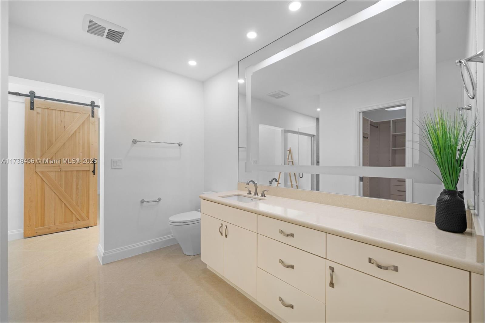 1144 Adams Street Hollywood, FL 33019 - Photo 19 of 51 a spacious bathroom with a granite countertop sink a toilet and a mirror