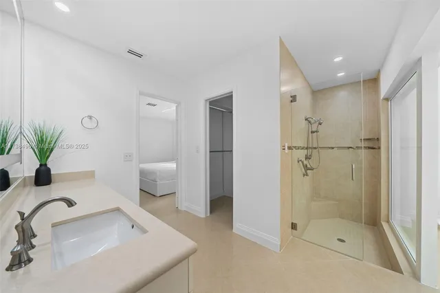 a bathroom with a glass shower door