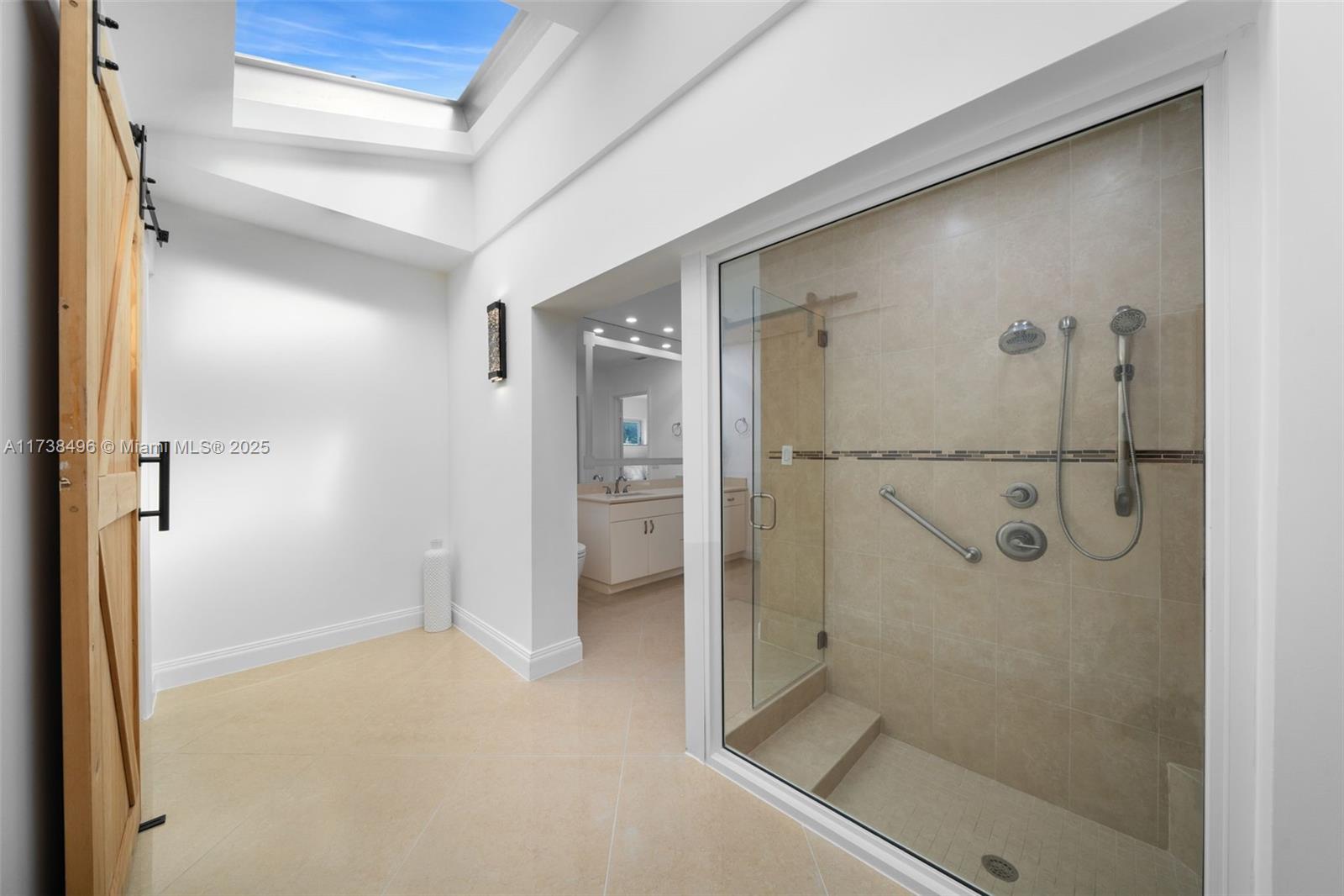 1144 Adams Street Hollywood, FL 33019 - Photo 23 of 51 a bathroom with a glass shower door