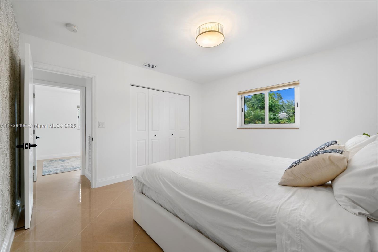 1144 Adams Street Hollywood, FL 33019 - Photo 34 of 51 a bedroom with a bed and a window