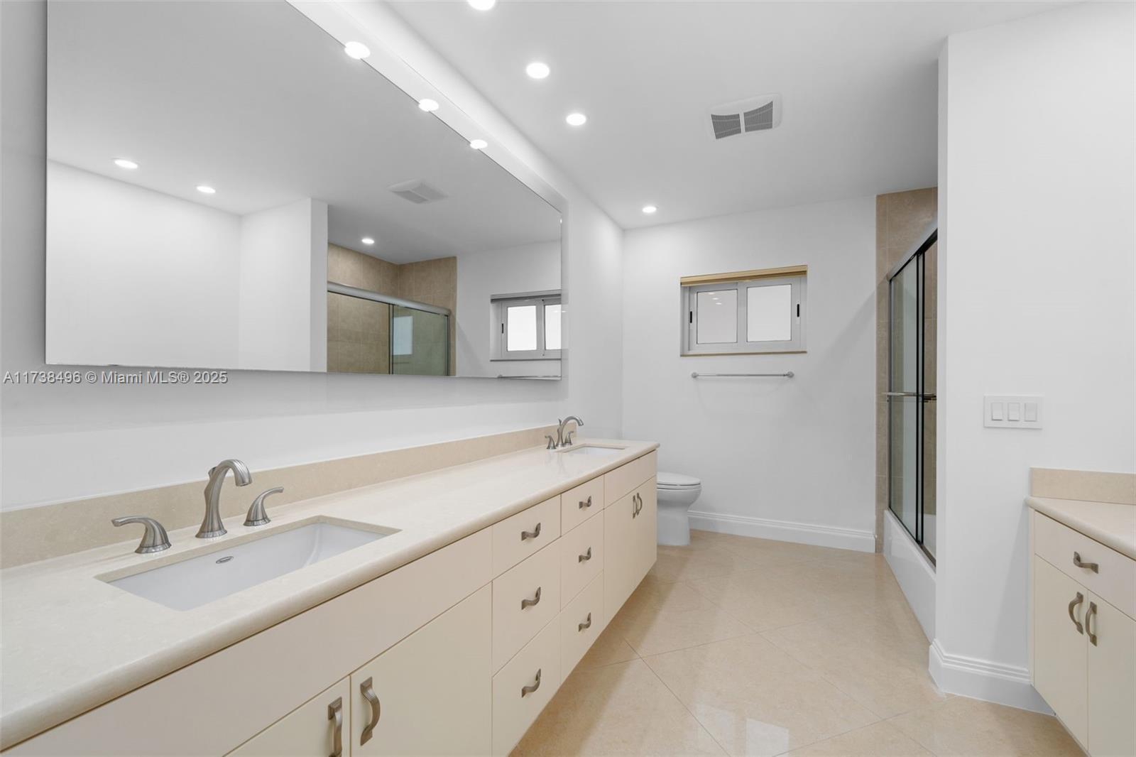 1144 Adams Street Hollywood, FL 33019 - Photo 35 of 51 a bathroom with a double vanity sink and mirror