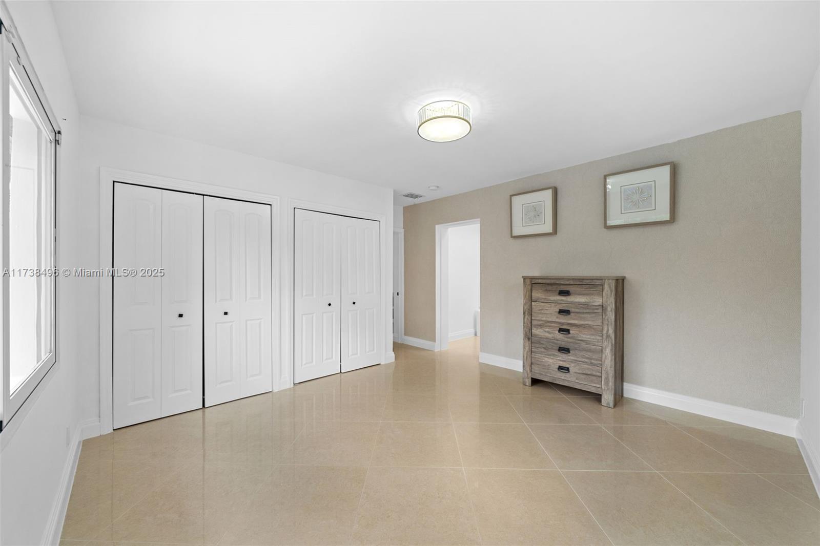 1144 Adams Street Hollywood, FL 33019 - Photo 44 of 51 an empty room with furniture and a window