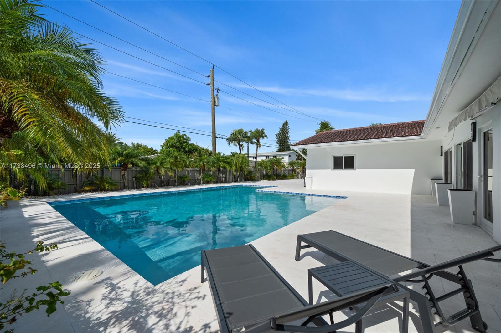 1144 Adams Street Hollywood, FL 33019 - Photo 48 of 51 a view of a patio with table and chairs with wooden floor and fence