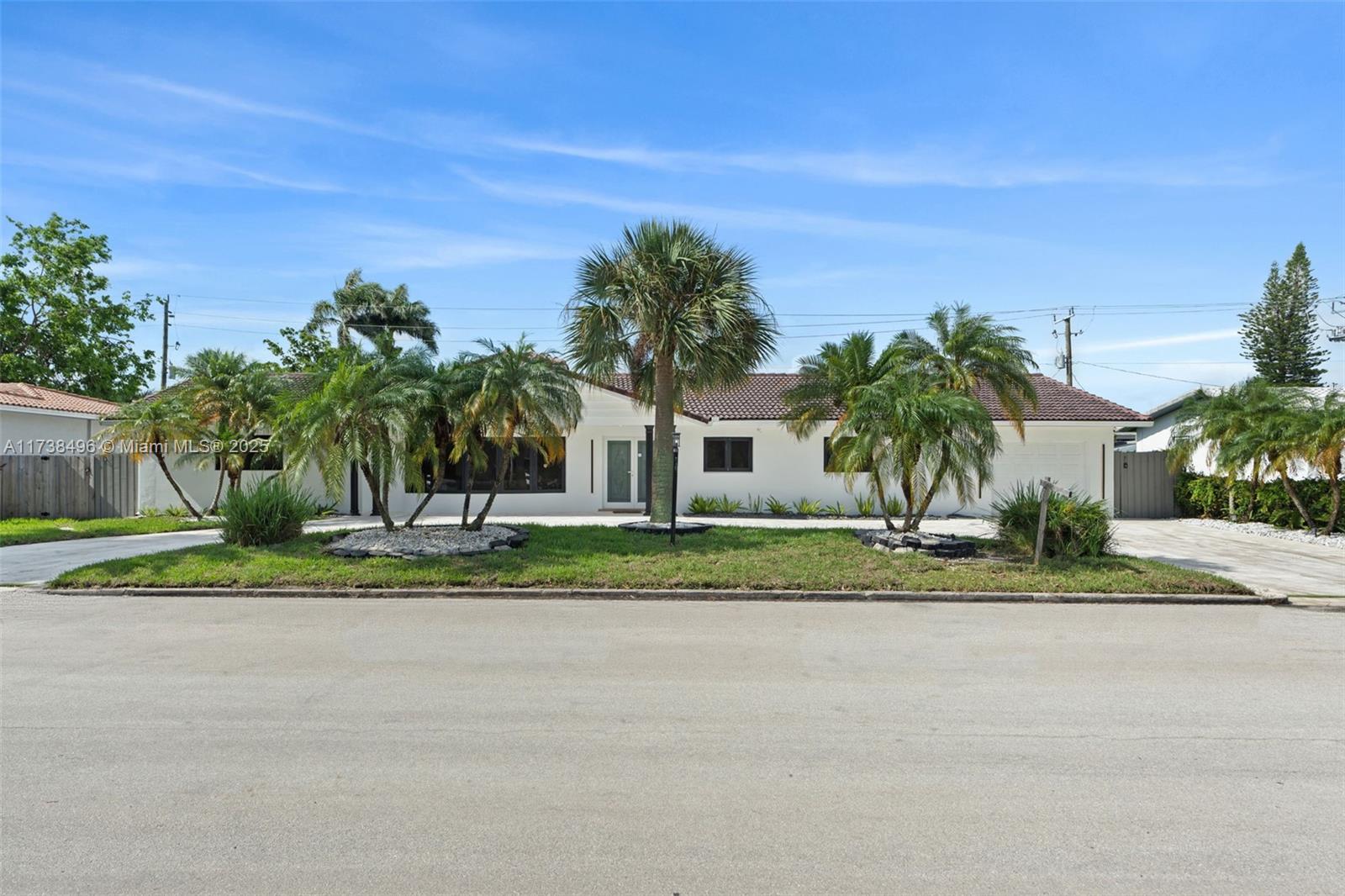 1144 Adams Street Hollywood, FL 33019 - Photo 50 of 51 a view of a house with a yard and palm trees