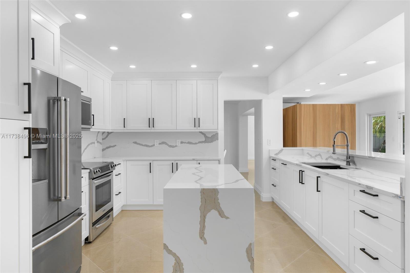 1144 Adams Street Hollywood, FL 33019 - Photo 8 of 51 a large kitchen with stainless steel appliances lots of counter space and a sink