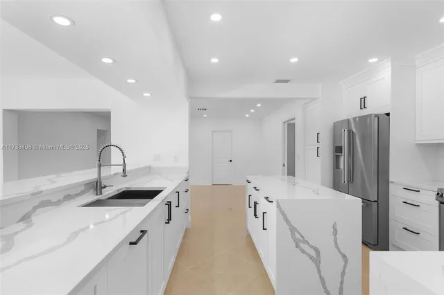 a kitchen with stainless steel appliances a sink stove and refrigerator