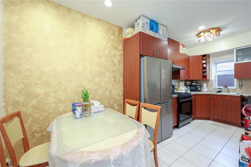 1663 West 6th Street, Unit 3B Brooklyn, NY 11223 - Photo 5 of 16 a kitchen with stainless steel appliances a refrigerator and a stove