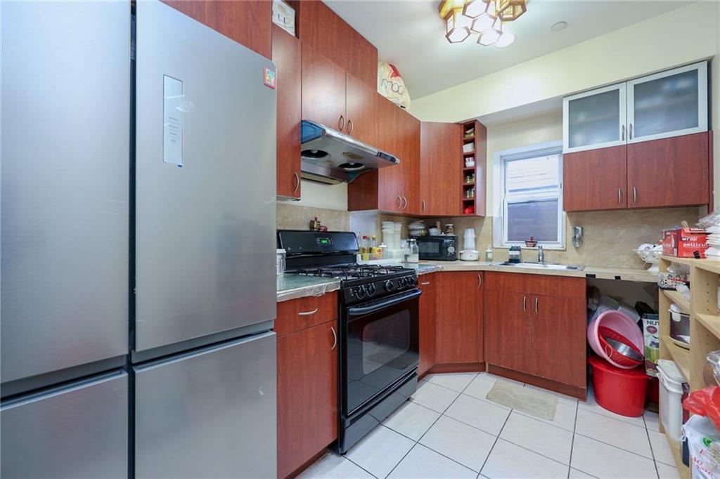 1663 West 6th Street, Unit 3B Brooklyn, NY 11223 - Photo 6 of 16 a kitchen with stainless steel appliances granite countertop a refrigerator and a stove