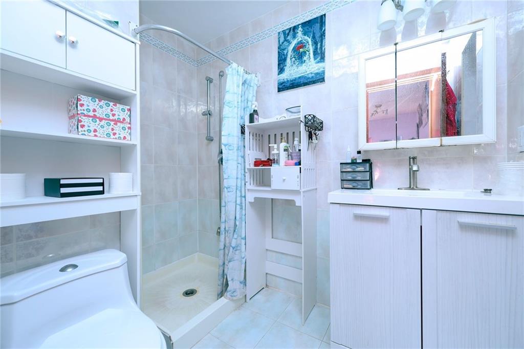 1663 West 6th Street, Unit 3B Brooklyn, NY 11223 - Photo 10 of 16 a bathroom with a sink toilet and shower