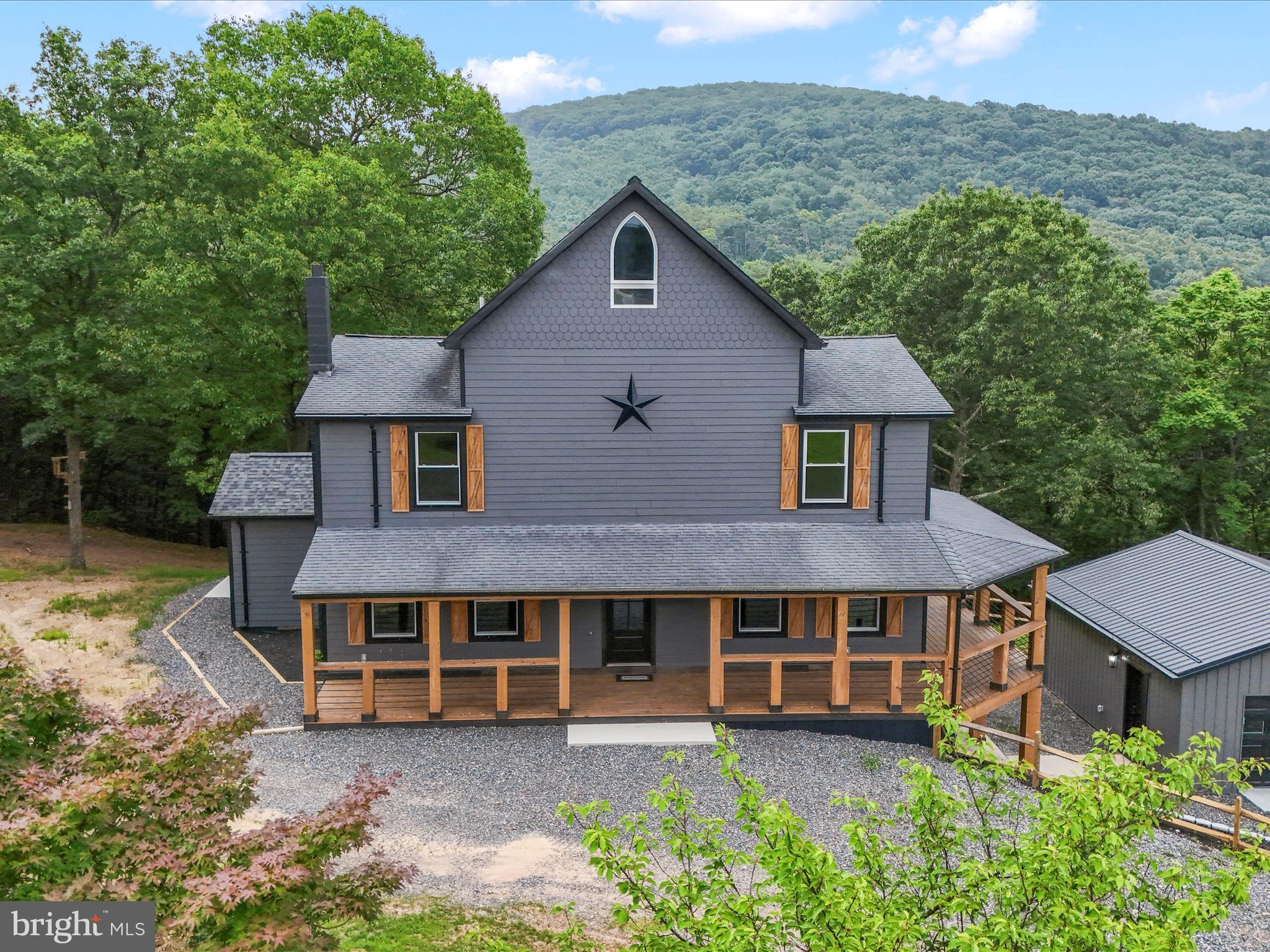 783 Community Way Road Romney, WV 26757 - Photo 2 of 83 a front view of a house with a garden