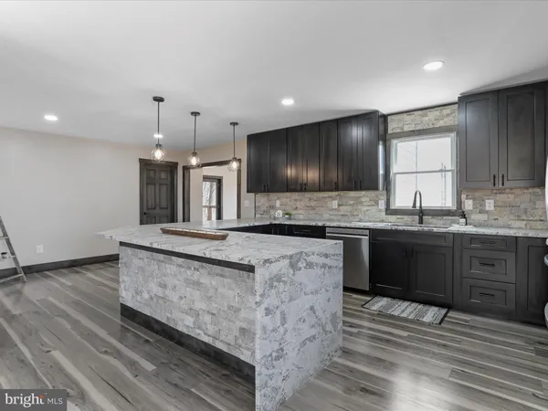 a kitchen with stainless steel appliances granite countertop a stove and a refrigerator