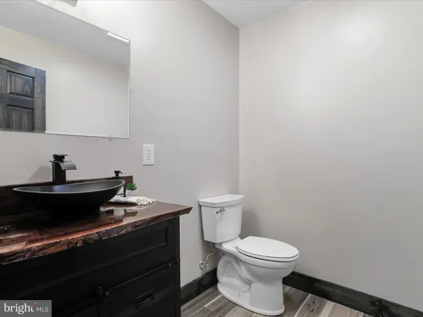 a bathroom with a granite countertop sink a toilet and bathtub