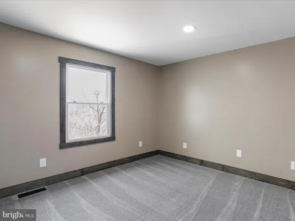 an aerial view of green landscape with trees houses and lake view