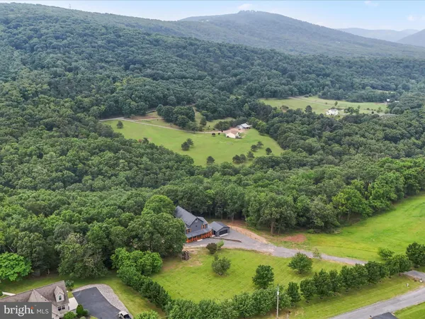 an aerial view of a house with a big yard