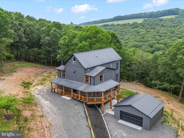 a aerial view of a house with pool table and chairs