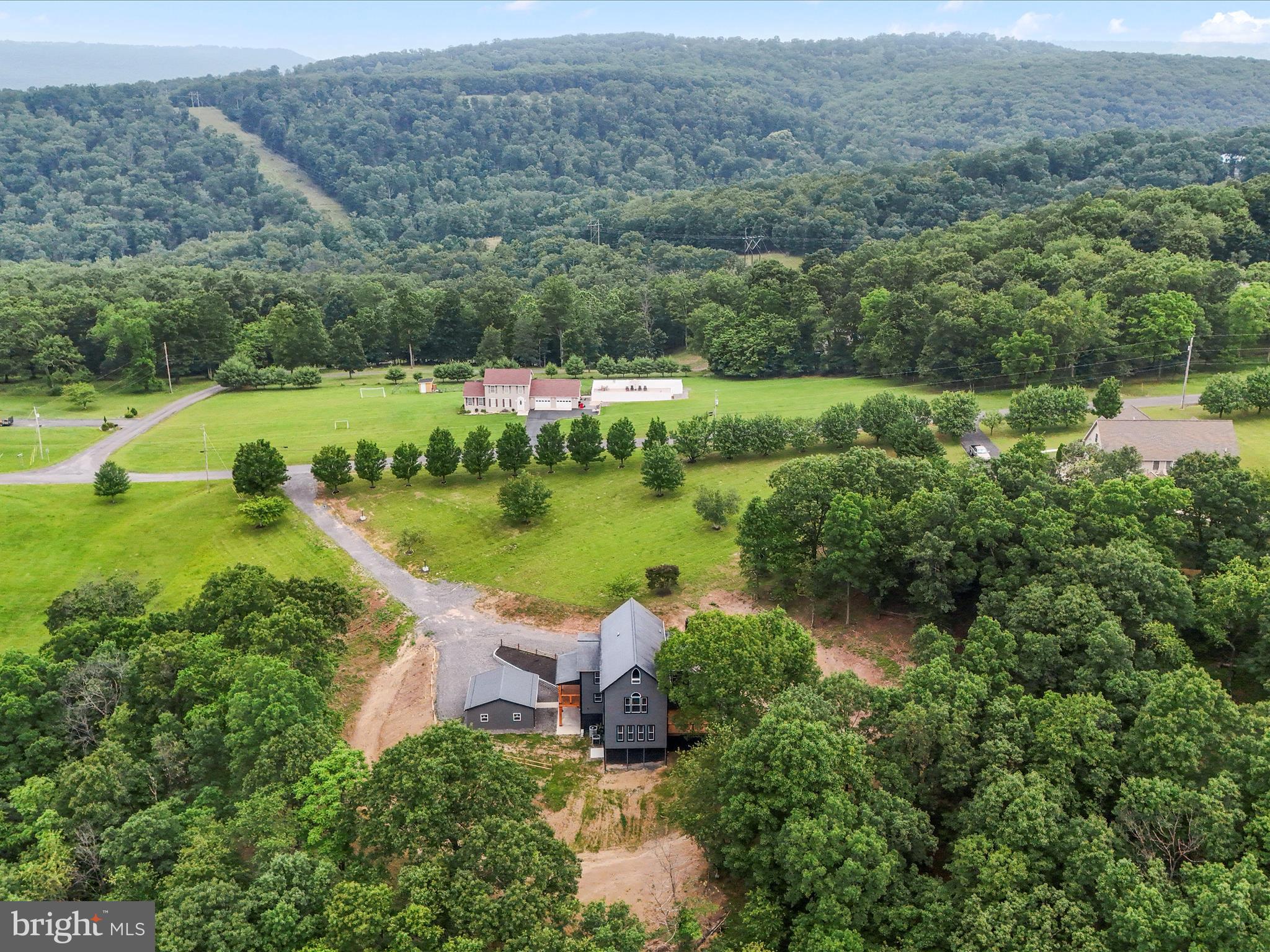 783 Community Way Road Romney, WV 26757 - Photo 82 of 83 an aerial view of green landscape with trees houses and lake view
