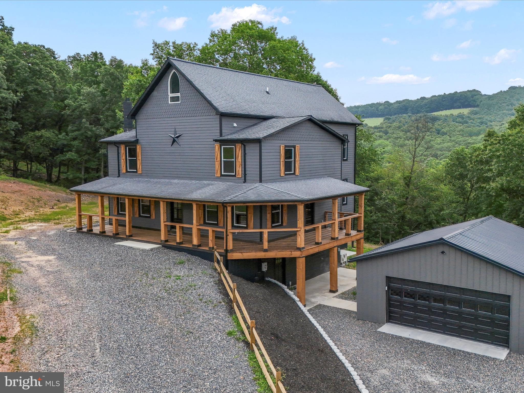 783 Community Way Road Romney, WV 26757 - Photo 9 of 83 a view of a house with a yard and balcony