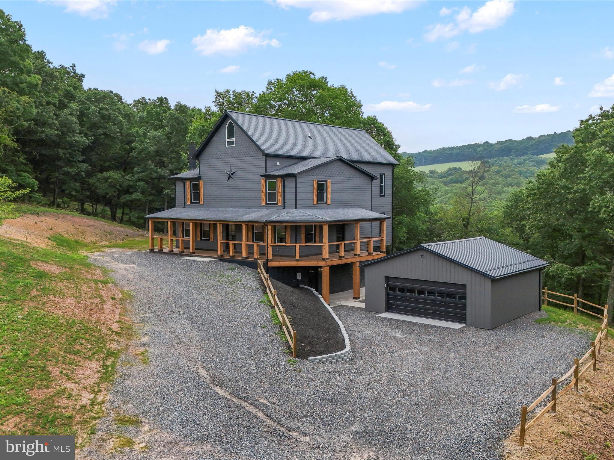 783 Community Way Road Romney, WV 26757 - Photo 10 of 83 a front view of a house with yard and trees in the background