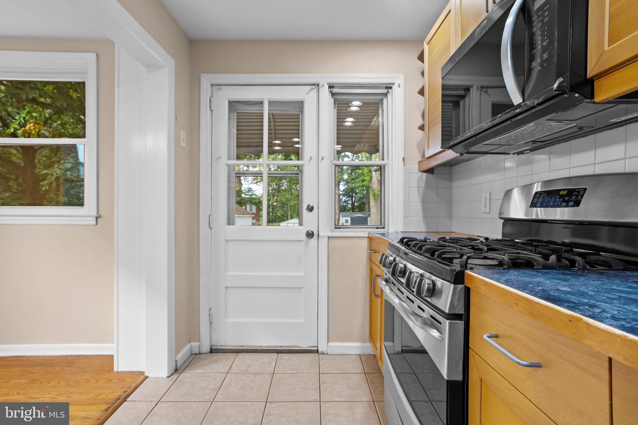 512 W Road Ridley Park, PA 19078 - Photo 11 of 25 a kitchen with granite countertop a stove and a refrigerator