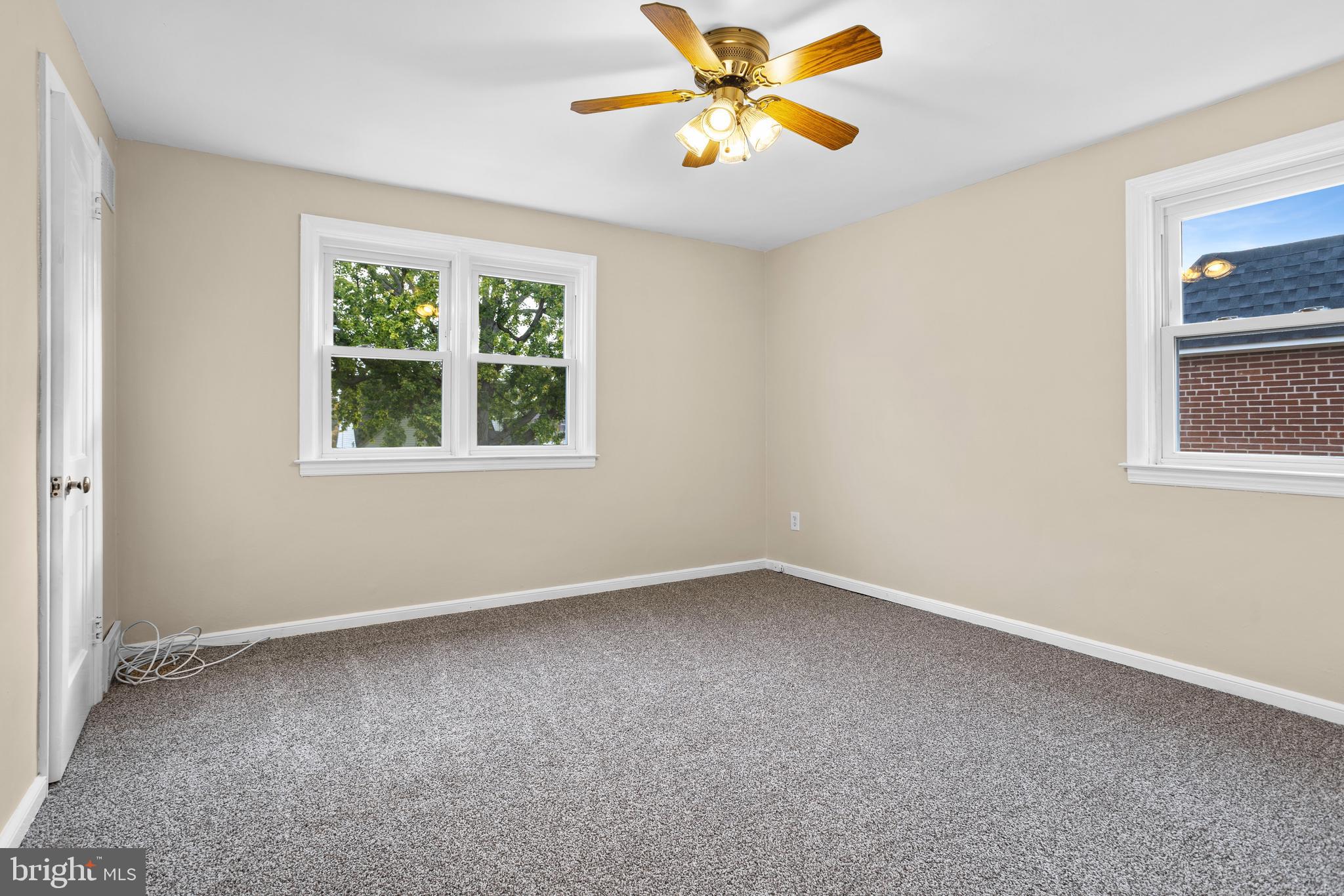 512 W Road Ridley Park, PA 19078 - Photo 12 of 25 an empty room with a window and a fan
