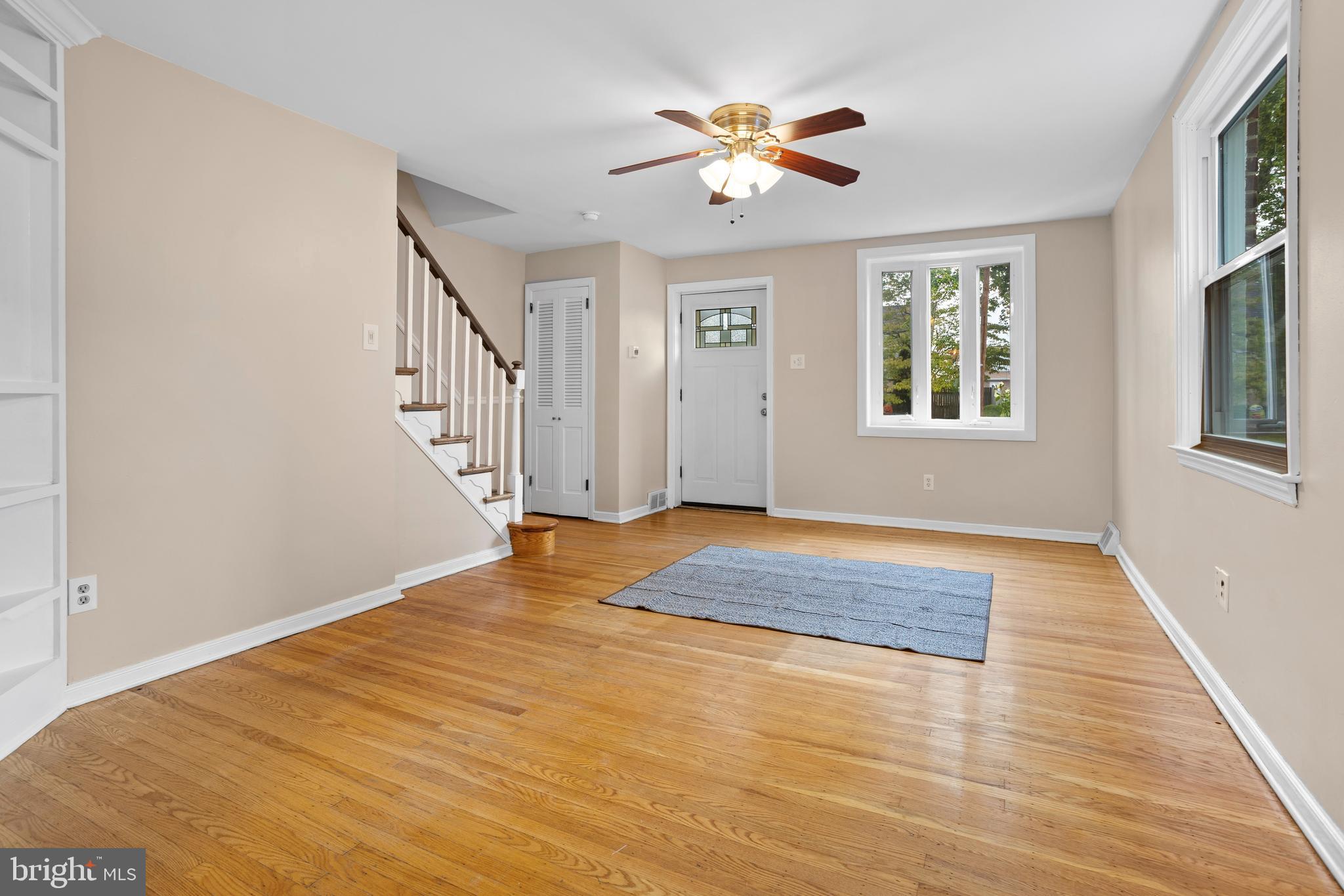 512 W Road Ridley Park, PA 19078 - Photo 4 of 25 a view of an empty room with a chandelier fan and a window