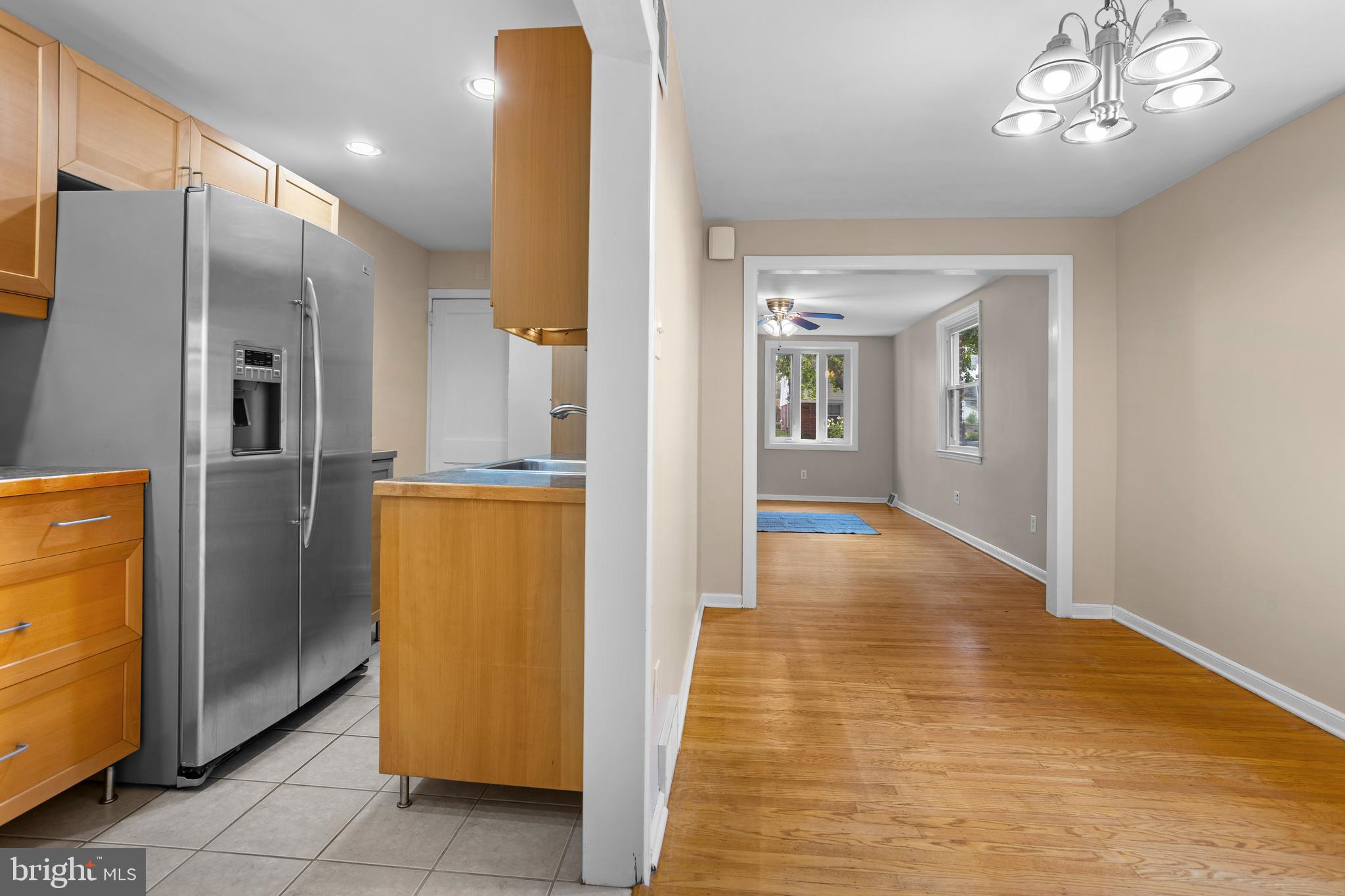 512 W Road Ridley Park, PA 19078 - Photo 8 of 25 a view of a hallway with wooden floor and a kitchen