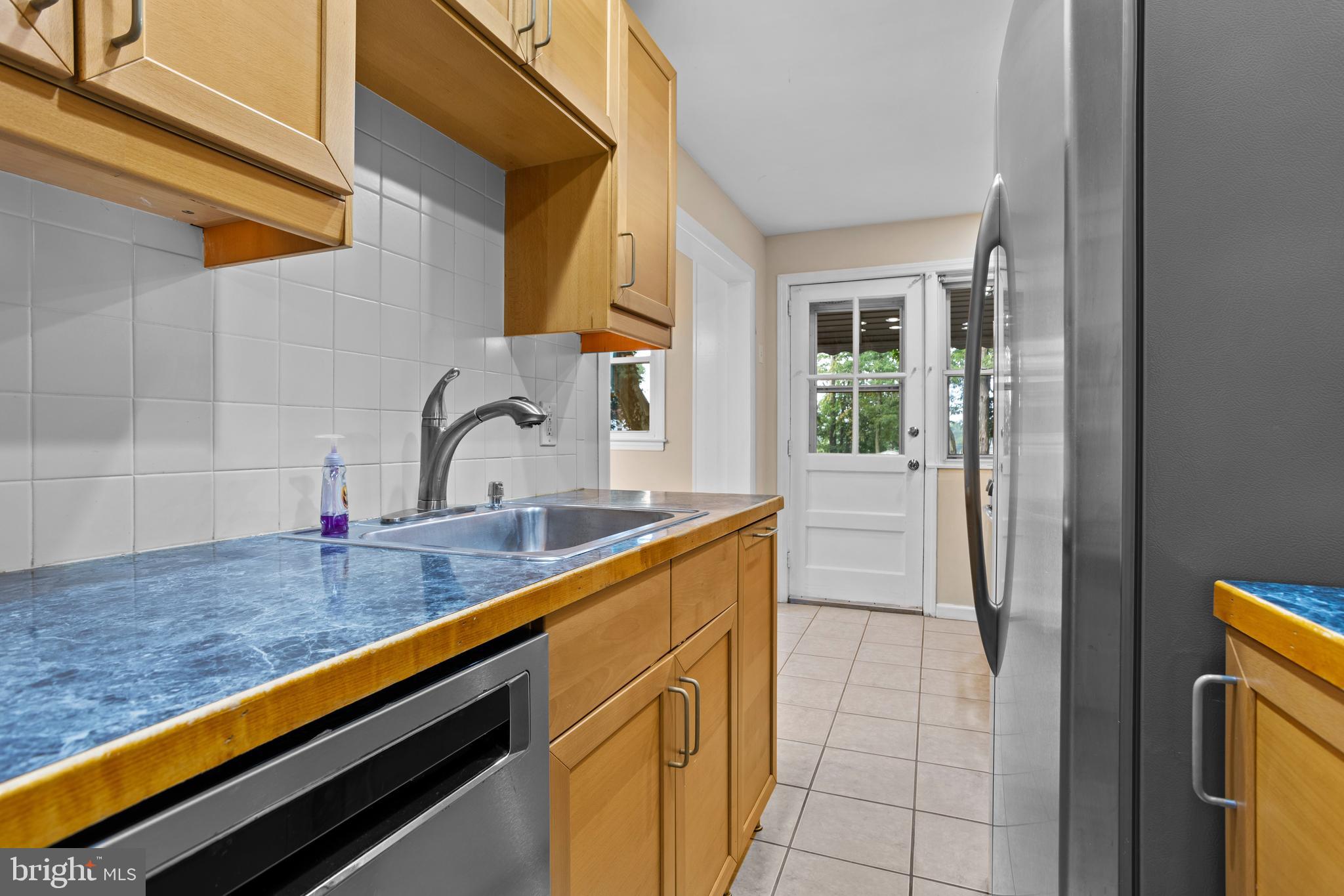 512 W Road Ridley Park, PA 19078 - Photo 10 of 25 a kitchen with a sink cabinets and a wooden floor