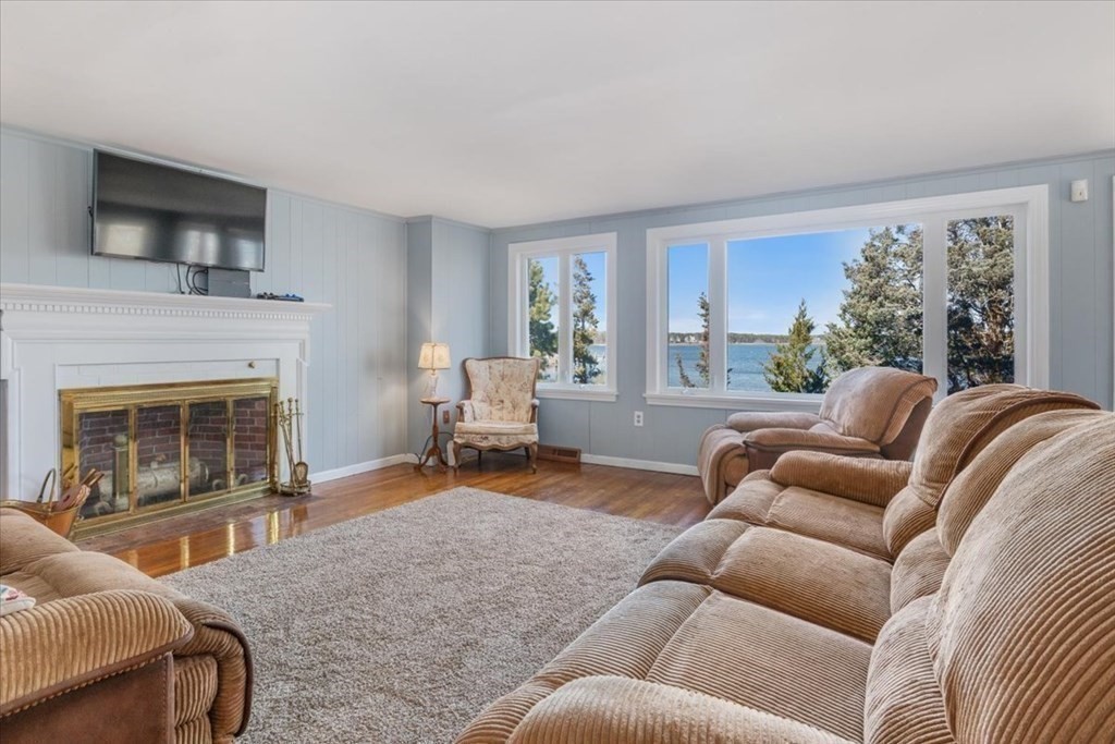 157 Daniels Island Road Mashpee, MA 02649 - Photo 16 of 41 a living room with furniture and a fireplace