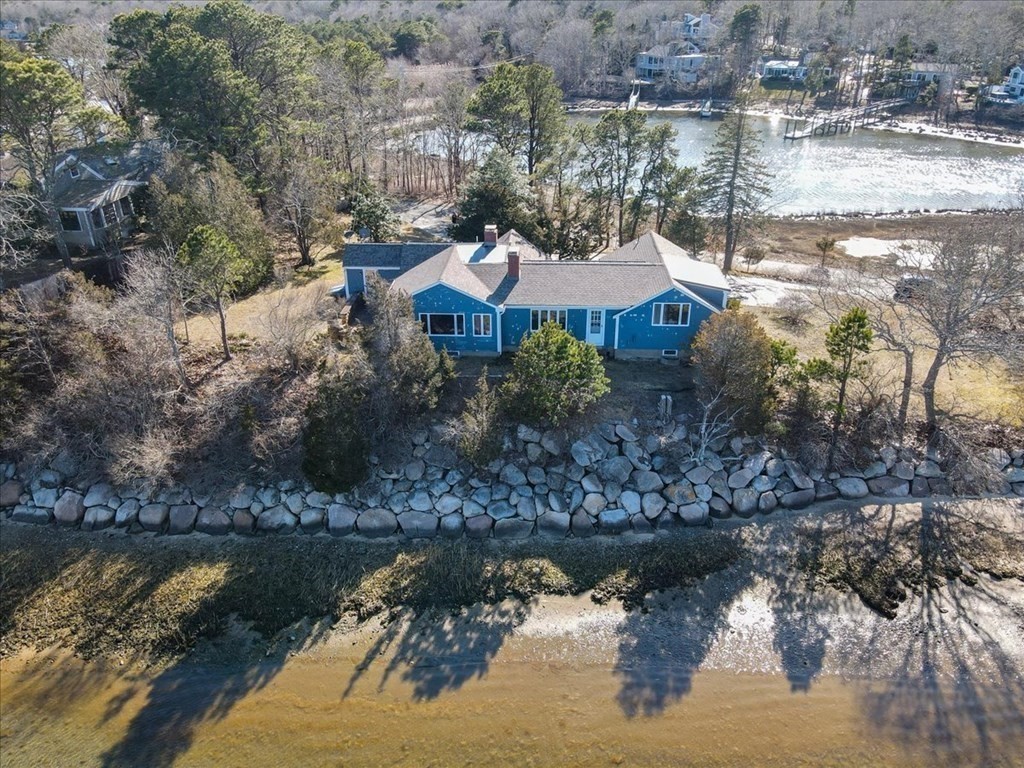 157 Daniels Island Road Mashpee, MA 02649 - Photo 2 of 41 a view of a lake with a house in the background