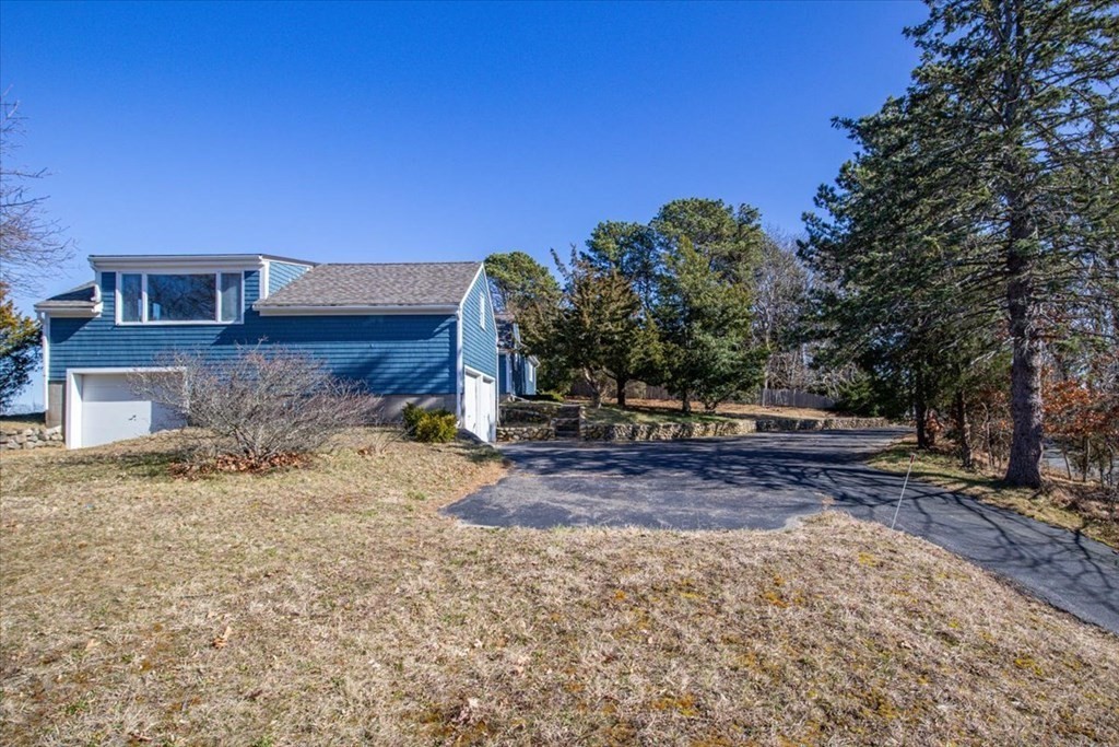 157 Daniels Island Road Mashpee, MA 02649 - Photo 36 of 41 a view of a yard with a house