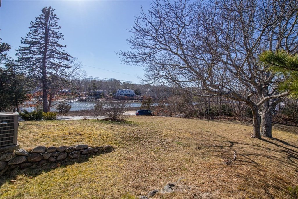 157 Daniels Island Road Mashpee, MA 02649 - Photo 39 of 41 a view of a yard with large trees